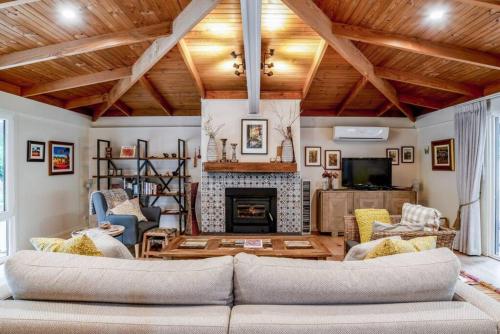 a living room with a couch and a fireplace at Eden Gardens in Scenic Aldgate in Aldgate