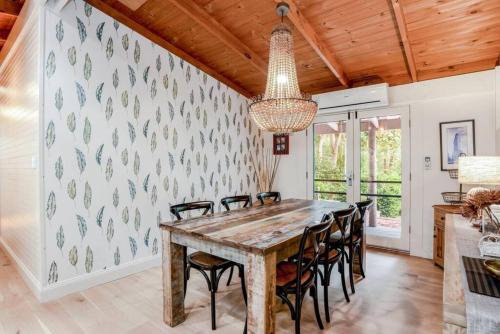 a dining room with a wooden table and chairs at Eden Gardens in Scenic Aldgate in Aldgate