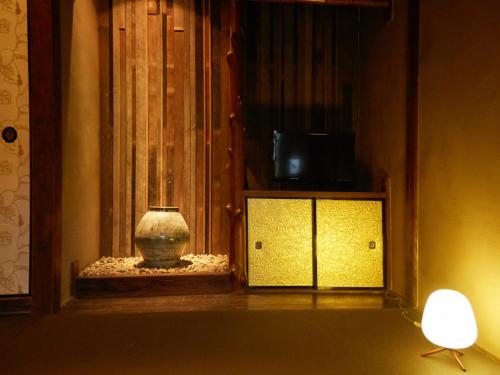 a vase sitting in a window in a room at sakainoma hotel 熊 in Sakai