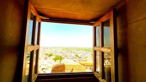 an open window with a view of a city at Hotel Lotus Haveli in Jaisalmer