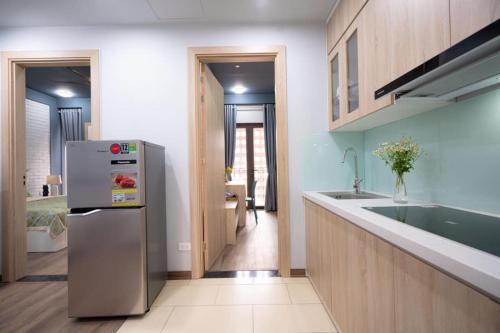 a kitchen with a refrigerator and a sink at 3BT home in Hanoi