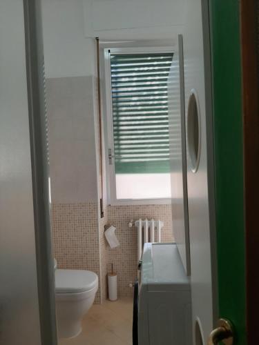 a small bathroom with a toilet and a window at Alloggio Desiri in Pavia