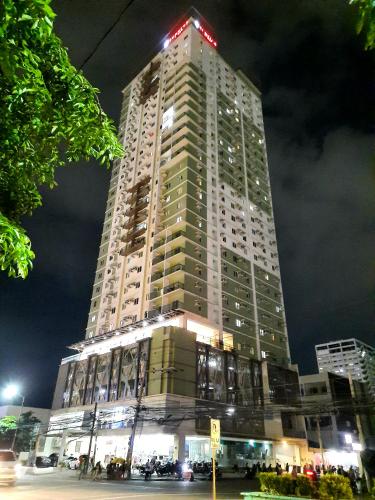 a tall building with lights on top of it at night at 1809 Sunvida Tower Condo across SM City Cebu in Cebu City