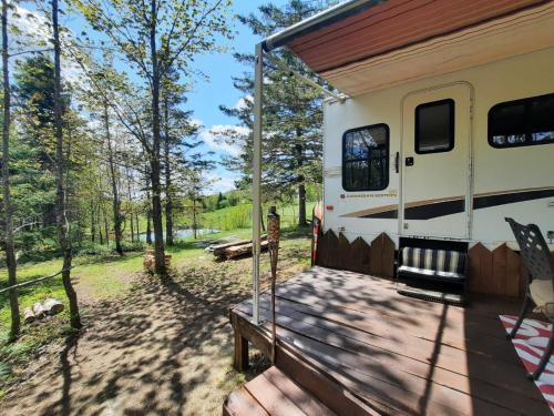an rv with a porch and a deck at Ranch vdv in Thetford Mines