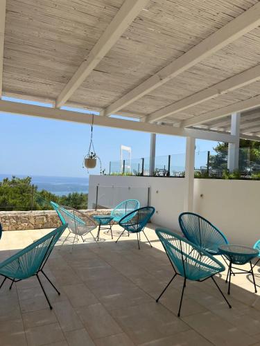a group of chairs and tables on a patio at Camping La Scogliera in Santa Cesarea Terme