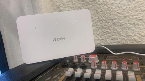 a white speaker sitting on top of an electronic keyboard at Sea view chalet in Taba