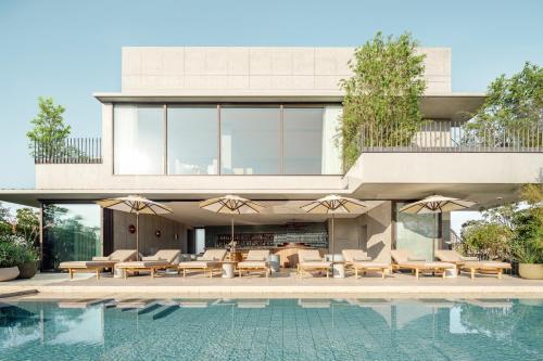 a house with a swimming pool next to a building at TRUNK(HOTEL) YOYOGI PARK in Tokyo