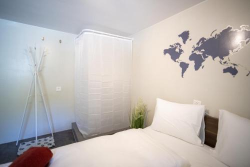 a bedroom with a world map on the wall at Chasa Muglin Ardez in Ardez