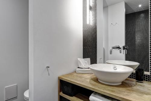 a bathroom with a white sink and a mirror at Gorki Apartments in Berlin