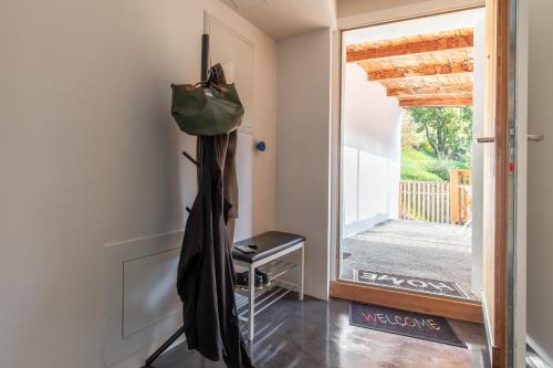 a hallway with an open door with a purse hanging on the wall at Chasa Muglin Ardez in Ardez