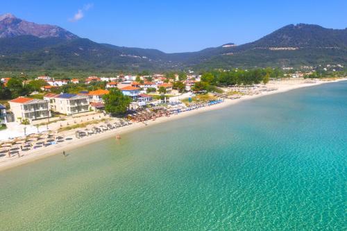 an aerial view of a beach with chairs and buildings at ILIORAMA LUXURY SUITES in Skala Potamias