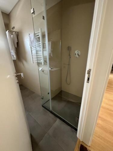 a bathroom with a shower with a glass shower stall at CASCAIS.IO in Cascais