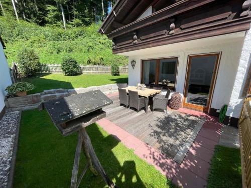 a backyard with a wooden deck with a table and chairs at Rehblick Waging in Waging am See