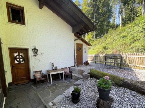 a patio of a house with a table and chairs at Rehblick Waging in Waging am See
