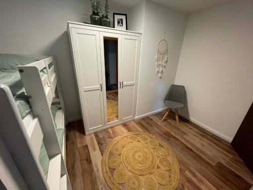 a small room with a bedroom with a mirror at Rehblick Waging in Waging am See