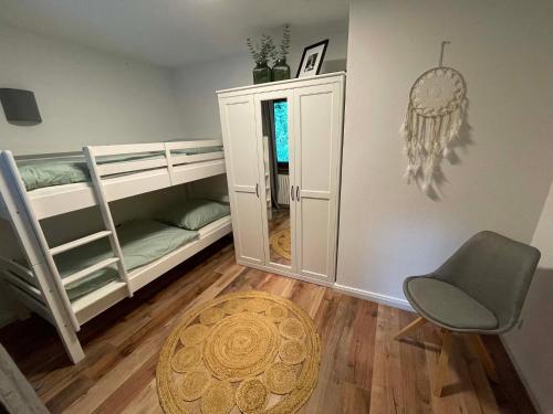 a room with a bunk bed and a chair at Rehblick Waging in Waging am See