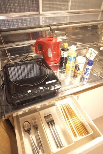 a refrigerator filled with food and utensils at Aioi Yanto 一日一組限定古民家宿 in Otaru