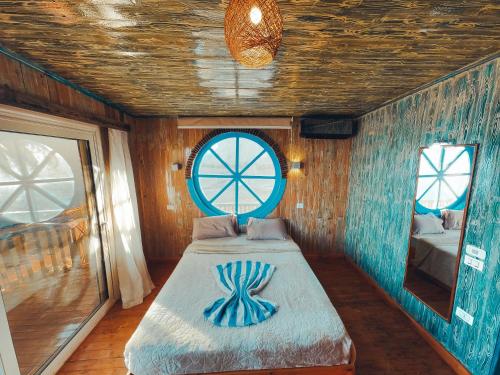 a room with a bed in a room with a window at New Moon Island Camp in Nuweiba