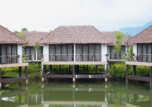 a row of cottages on the water at Good Time Relax Resort in Kampot