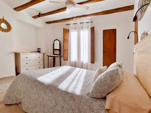 a bedroom with a large bed and a window at Ca tia Teresa in Planes