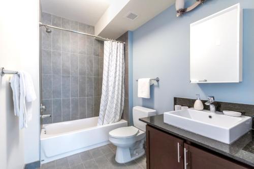 a bathroom with a sink and a toilet and a tub at Loop 2BR w Gym Pool WD nr Financial District CHI-208 in Chicago