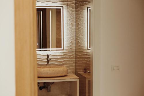 a bathroom with a sink and a mirror at Oniro by Iliria Palace in Himare