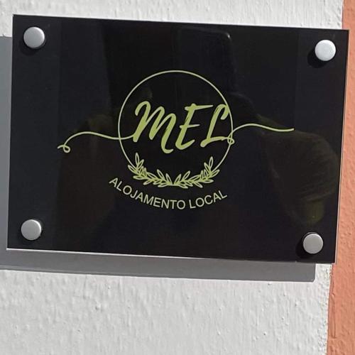 a sign for a restaurant with the letters melta at MEL in Alagoa