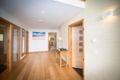 a hallway of a house with a desk and a door at Atlas in Nairn