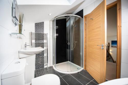 a bathroom with a shower and a toilet and a sink at Atlas in Nairn