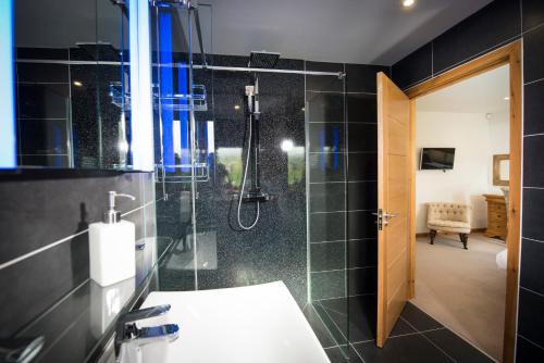 a bathroom with a shower and a toilet and a sink at Atlas in Nairn