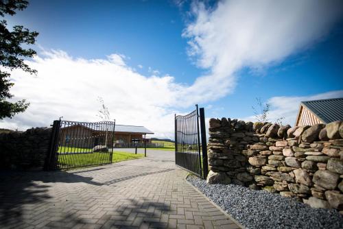 a stone fence with a gate and a stone wall at Atlas in Nairn