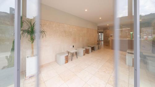 a bathroom with a row of sinks and toilets at Geoje Mongdol Beach H Avenue Hotel in Geoje 