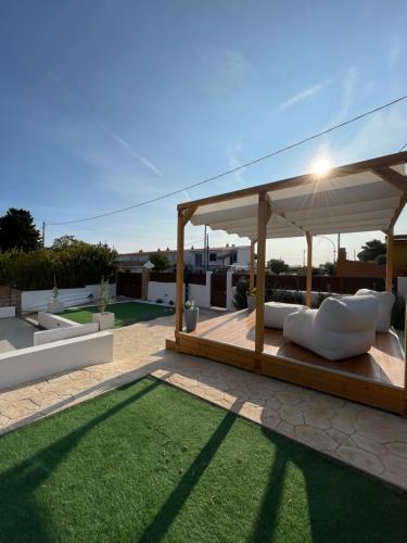 a patio with a gazebo and a green lawn at Casa Miele in Santa Lucia