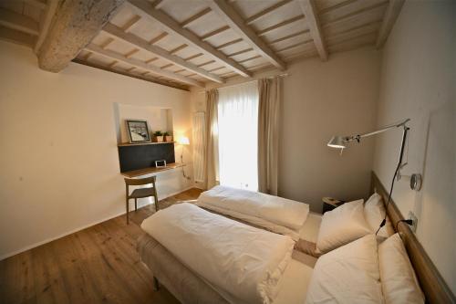 a bedroom with two beds and a desk in it at 32 BnB Camerecaffè in Pavia