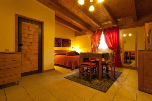 a bedroom with a bed and a table and chairs at Valentino in Valenzano