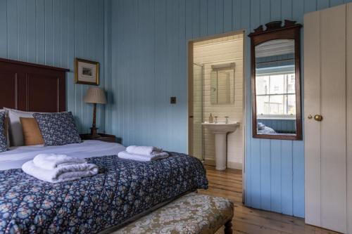 a bedroom with a bed with towels on it at Merrion Mews in Dublin