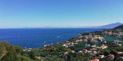 a town on a hill next to the water at Suggestivo appartamento vista mare in palazzo del'400 in Massa Lubrense