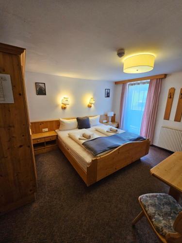 a bedroom with a large bed in a room at Die Schlickeralm in Telfes im Stubai