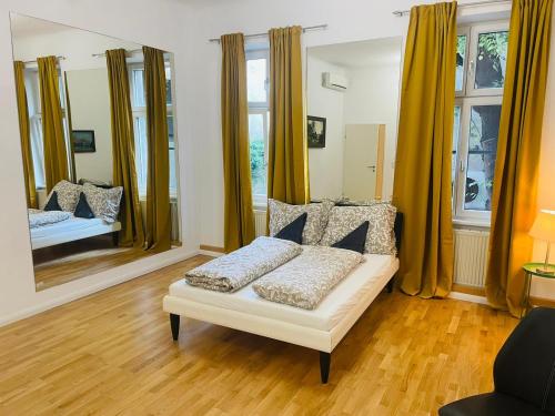 a living room with a couch and a mirror at Direct city center-privat rooms-5 Minutes Mariahilferstraße in Vienna