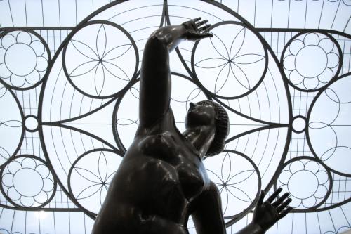 a statue of a woman in front of a stained glass window at Grand Hotel et de Milan - The Leading Hotels of the World in Milan