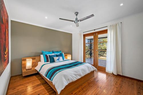 a bedroom with a bed and a window at Coopers Run in Millfield