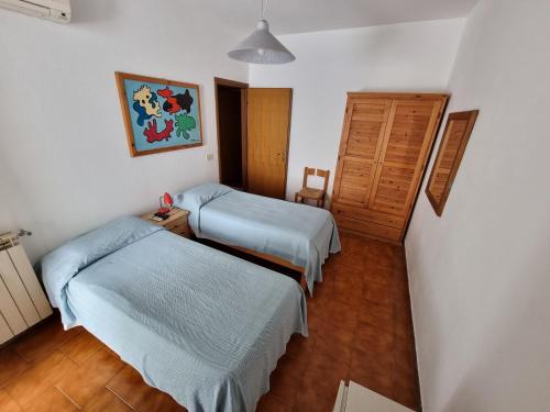 um quarto de hospital com duas camas e um armário em Ischia Villa Casa Caruso con piscina 6 posti letto em Ischia