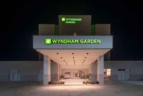 a building with a sign that reads w withdrawal garden garden at Wyndham Garden El Morro Montecristi in El Rincón