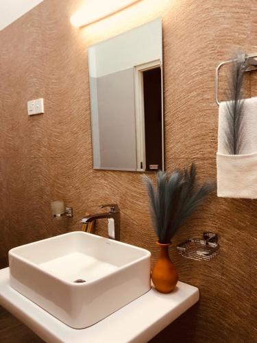 a bathroom with a white sink and a mirror at Ace Boutique Airport in Katunayaka