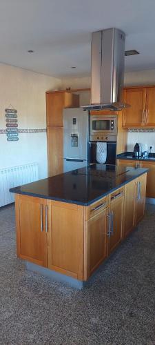 a kitchen with a large island in the middle at Lugar de Levides in Levide