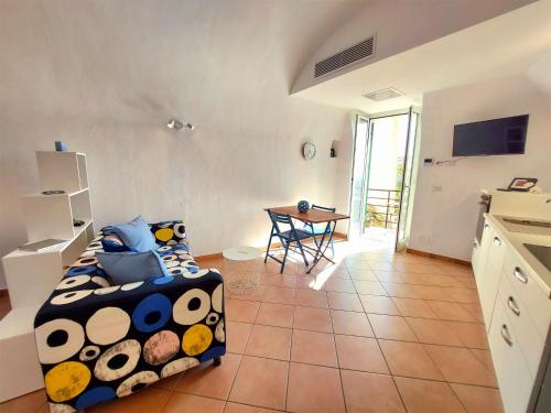 a bedroom with a bed and a table in a room at Il 55 dei Bastioni in Bordighera