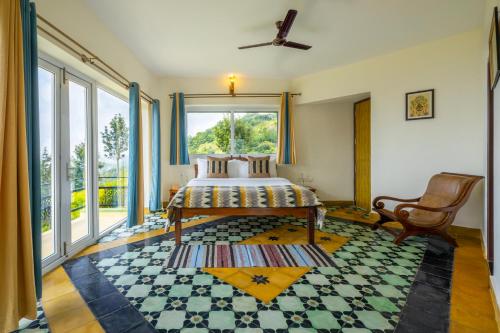 a bedroom with a bed and a large window at ama Stays & Trails Anjanagiri , Kotagiri in Kotagiri