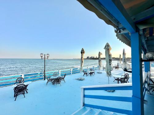 a beach with chairs and umbrellas and the ocean at Sunsilva in Olimp