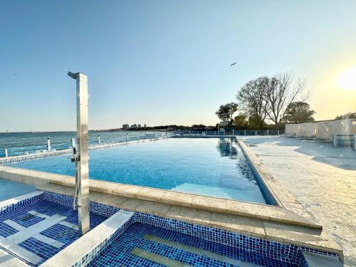 a swimming pool next to a body of water at Sunsilva in Olimp