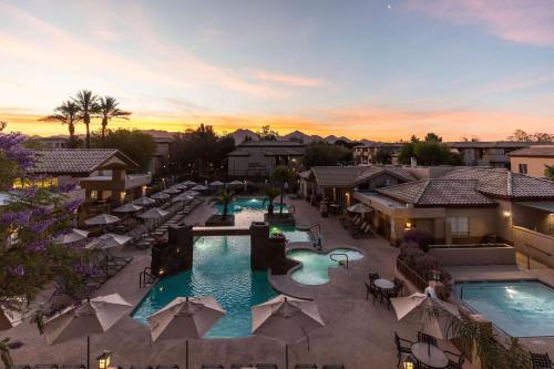 an aerial view of a resort with two pools and umbrellas at Hilton Vacation Club Scottsdale Villa Mirage in Scottsdale